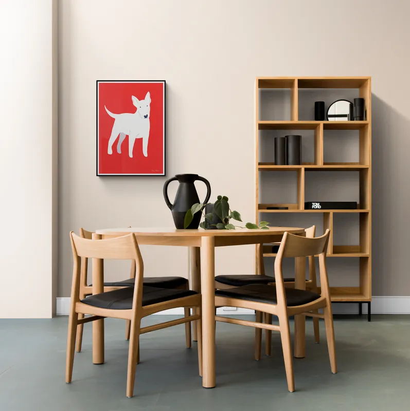 Framed art print shown on a wall above a dining table, made as a catalogue mockup